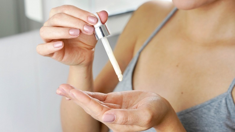 Woman holds dropper