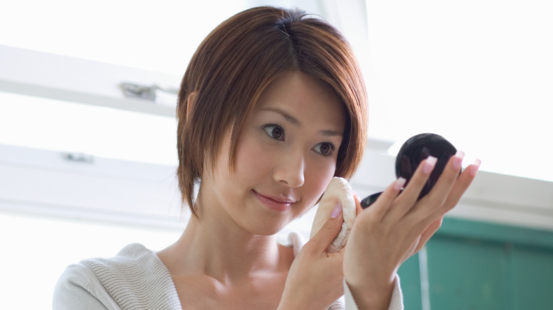 Woman applying powder