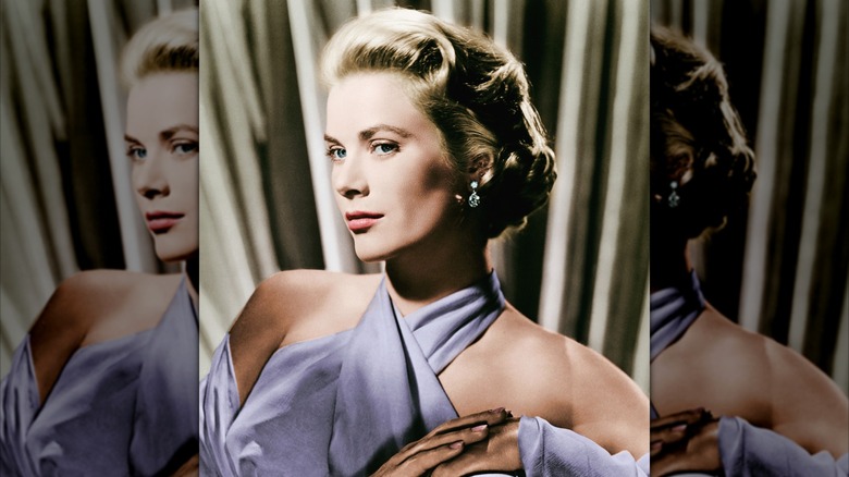 Grace Kelly in a lavender top and shawl with her hands clasped