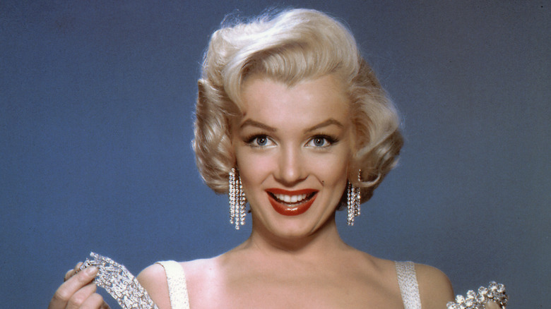 Marilyn Monroe posing with diamonds, wearing red lipstick