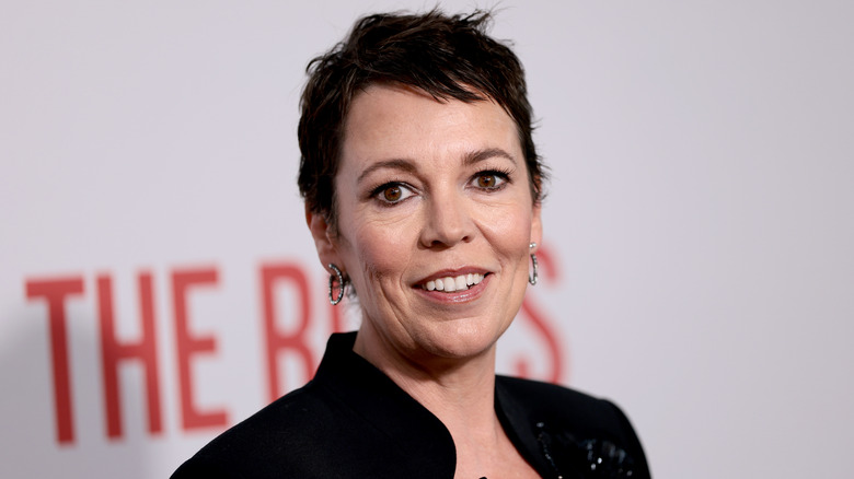 Olivia Colman on the red carpet with a short brunette haircut