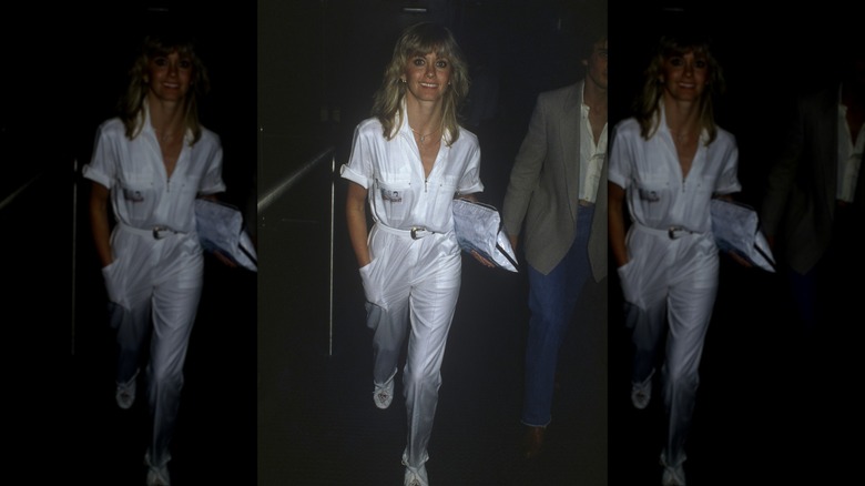 Olivia Newton-John walking in New York City in 1983 in a white jumpsuit