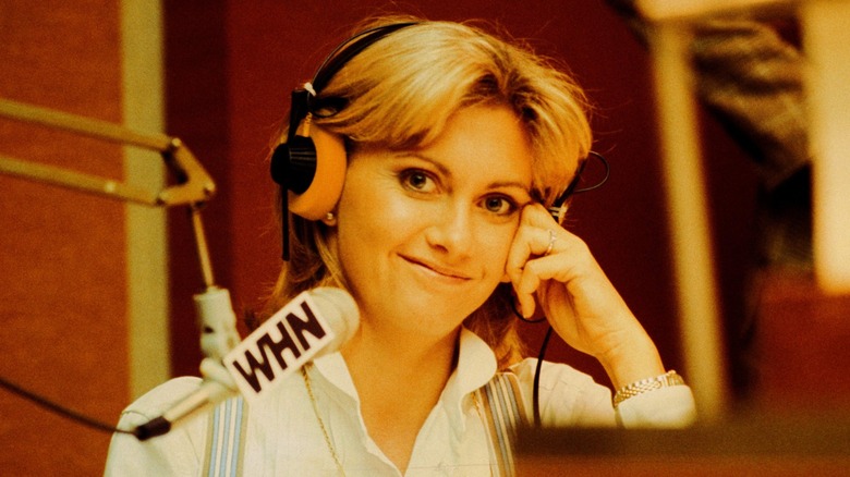 Olivia Newton-John at a radio station wearing headphones in 1980