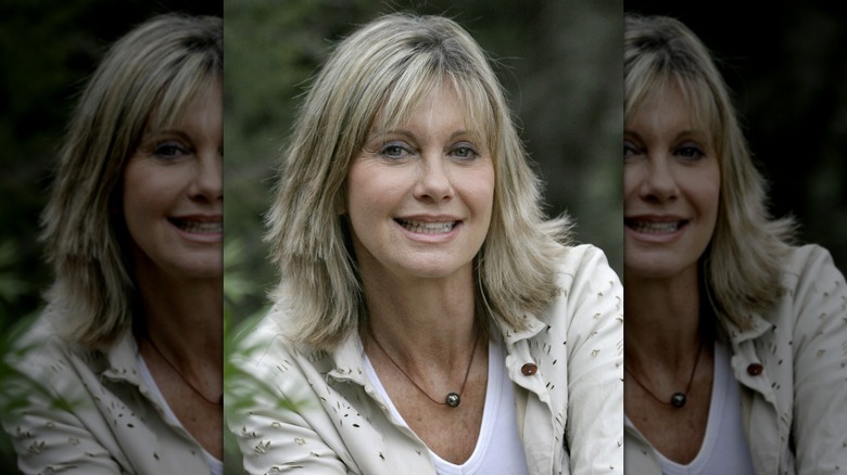 Olivia Newton-John smiling while outside in 2005