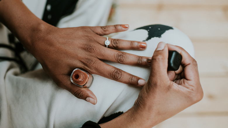 woman giving herself a manicure