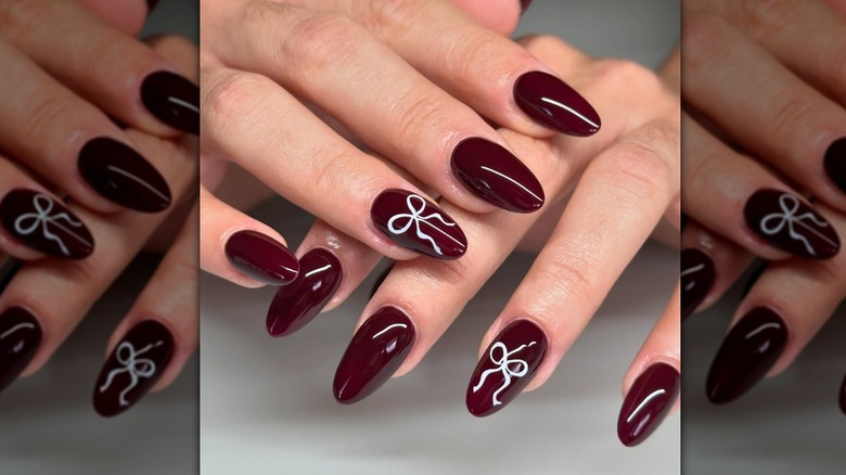 burgundy nails with accent bow nail