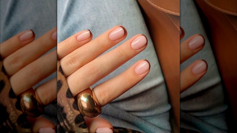 A French tip manicure on Instagram with brown tips