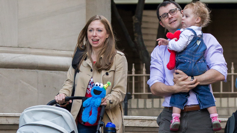 Chelsea Clinton and Marc Mezvinsky out with their child