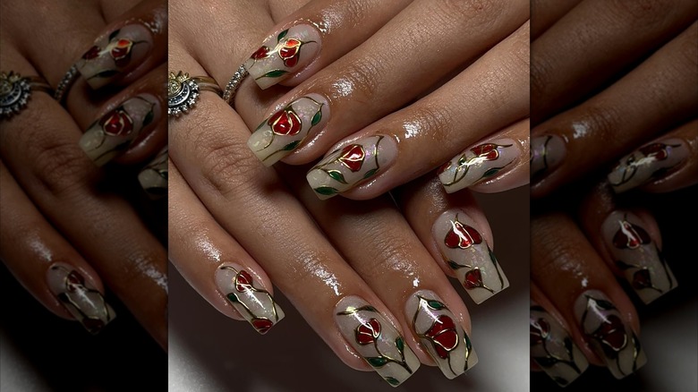 Overlapping hands showing rose designs over opal nails