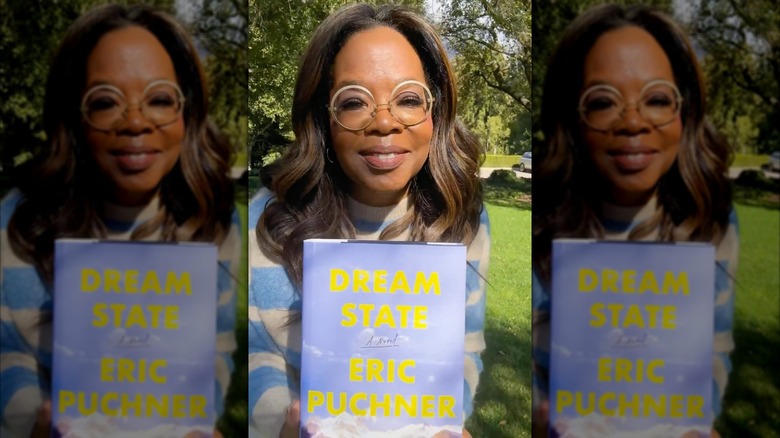 Oprah Winfrey holding a copy of Dream State by Eric Puchner
