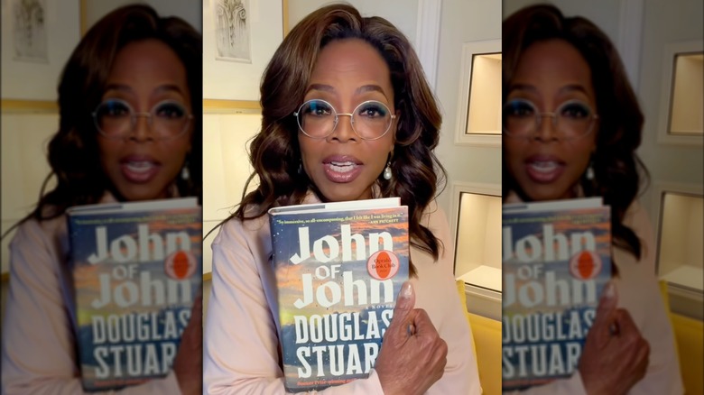Oprah Winfrey holding up a copy of John of John on Instagram