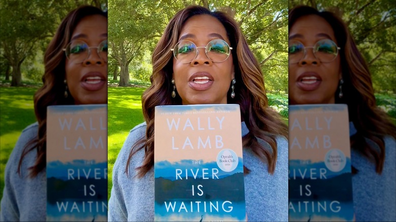 Oprah Winfrey holding a copy of The River Is Waiting by Wally Lamb