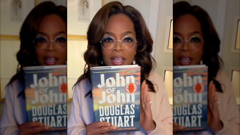 Oprah Winfrey holding a copy of John of John by Douglas Stuart