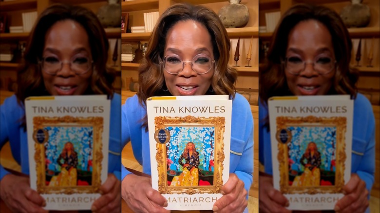 Oprah Winfrey holding a copy of Matriarch: A Memoir by Tina Knowles