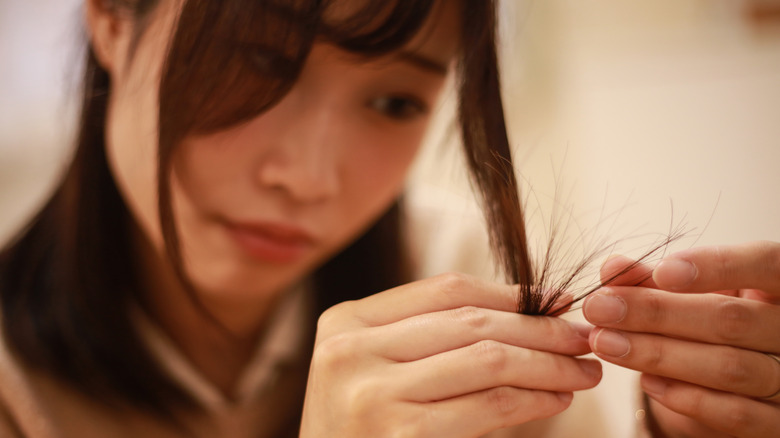 Woman looking at her hair