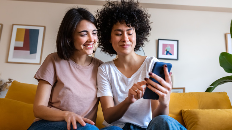 Same sex couple looking at phone
