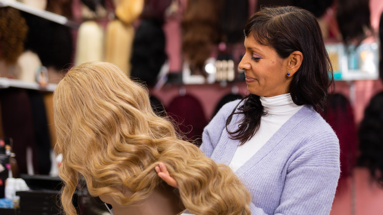 Woman holding wig