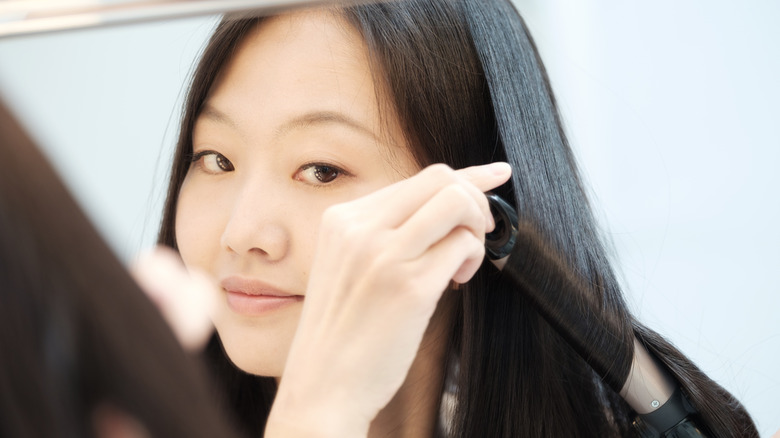 Woman curling her hair