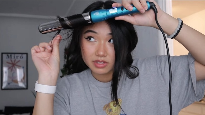 Woman curling her hair