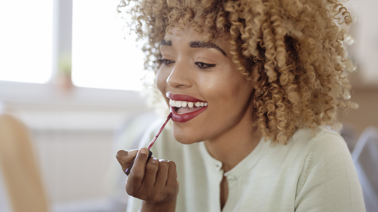 Applying lipstick
