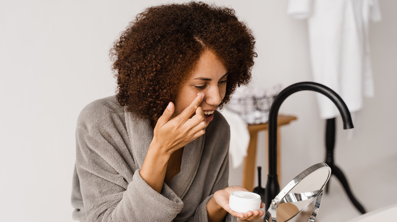Applying eye cream