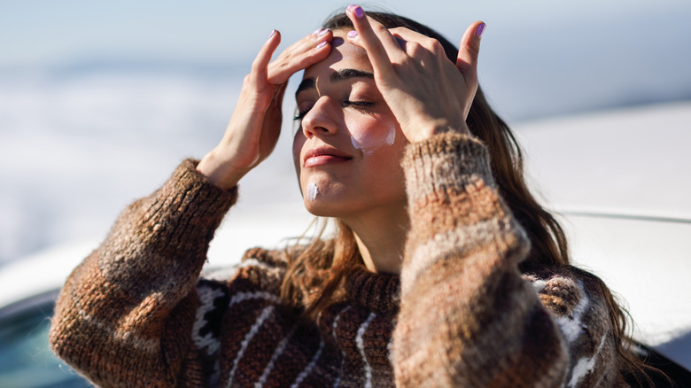 Woman applying sunscreen
