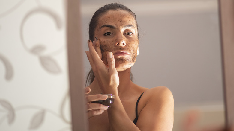 Woman exfoliating skin