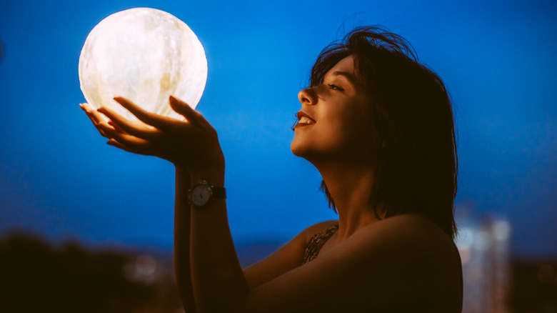 woman holding moon