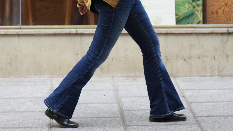 Woman walking wearing bell bottoms