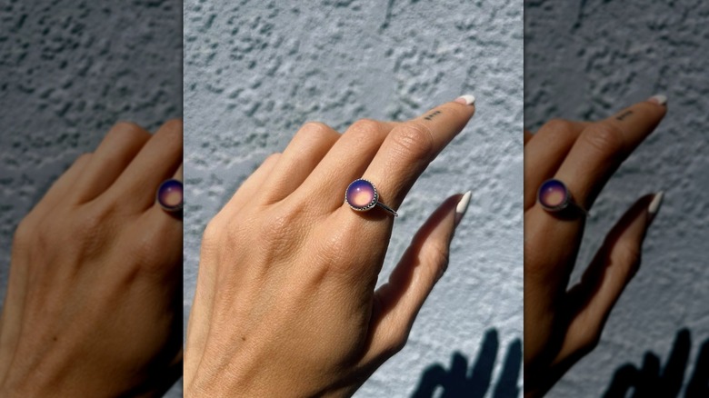 Hand wearing mood ring
