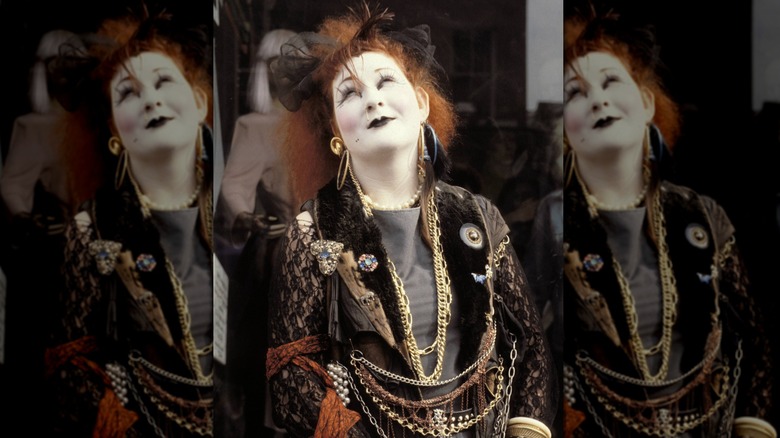 Punk woman with dyed red hair and a lot of accessories