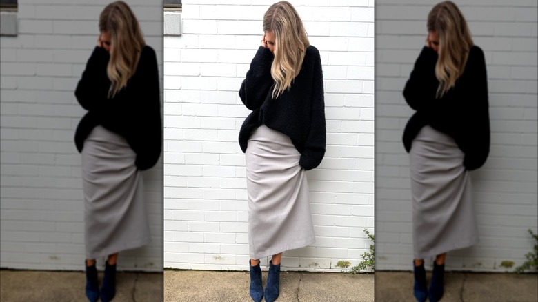 A woman on Instagram wearing a skirt and ankle boots