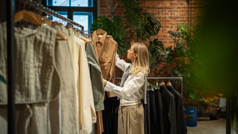 Woman looking at clothing on different racks