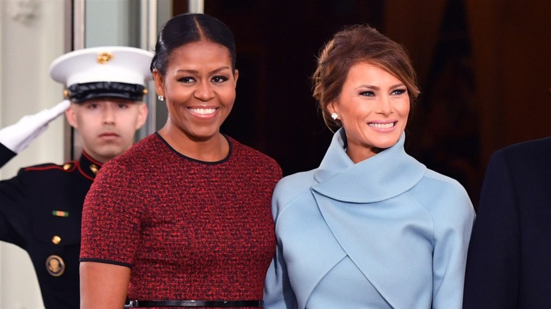 Michelle Obama smiling with Melania Trump