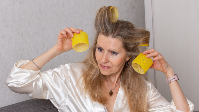 Woman using velcro rollers