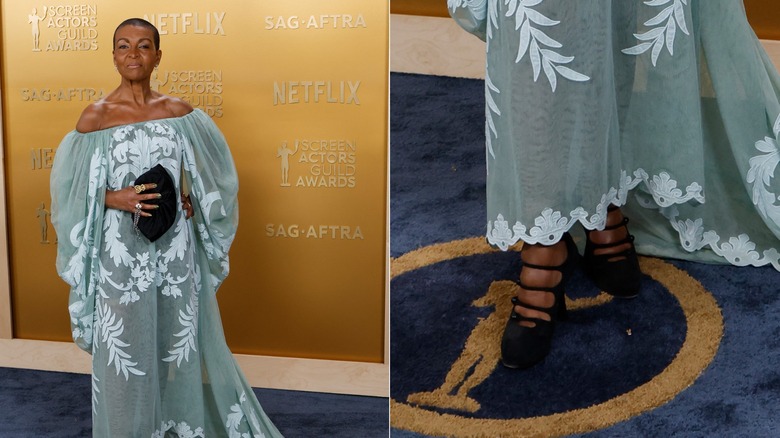 Adjoa Andoh wearing a blue mesh dress and strappy black heels