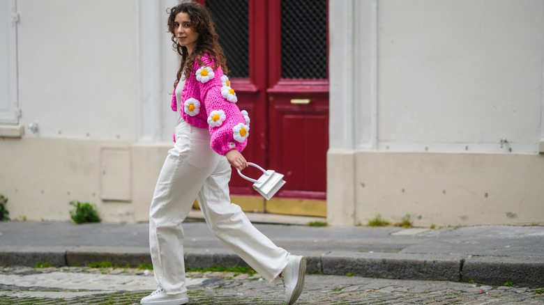 A woman wearing black, chunky sneakers and a black outfit