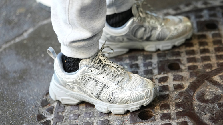 Someone outside wearing Christian Dior sneakers