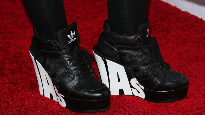 A woman wearing wedge Adidas sneakers on a red carpet