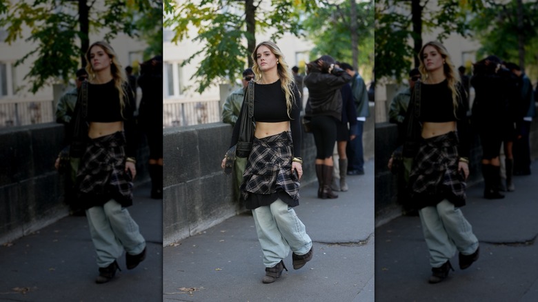 Woman in crop top and skirt over pants in September 2025
