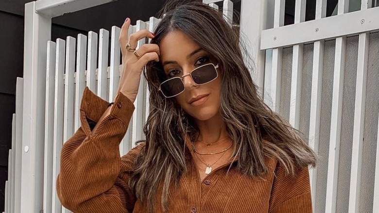 A woman wearing skinny, rectangular sunglasses