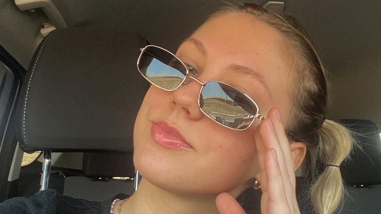A woman in skinny, rectangular sunglasses