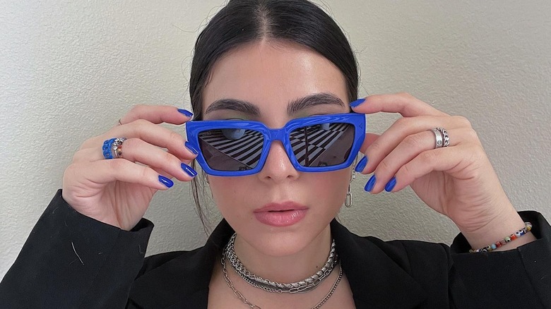 A woman in blue sunglasses