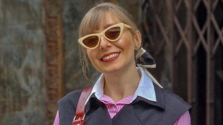 A woman wearing lifted sunglasses