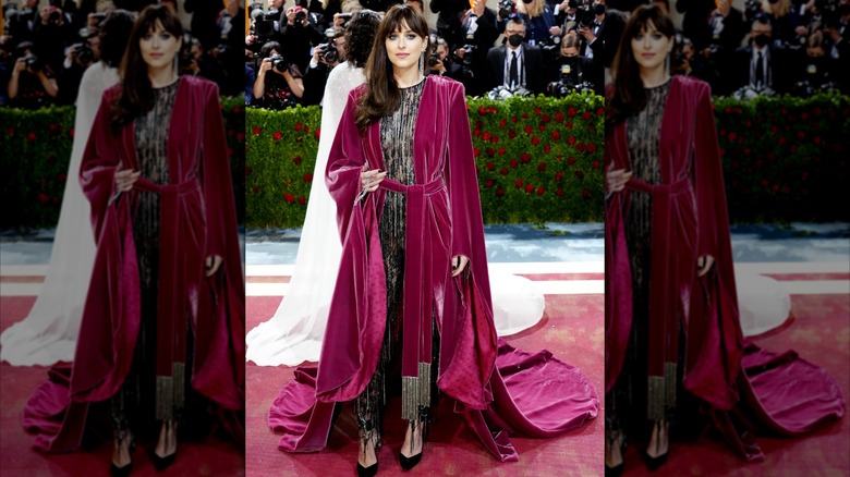 Dakota Johnson at the Met Gala in a red velvet housecoat