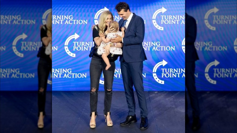 Erika and Charlie Kirk at at Turning Point USA event with their child