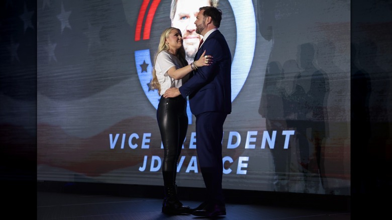Erika Kirk hugging JD Vance on stage while wearing tight leather pants