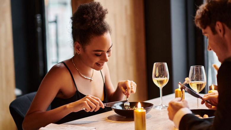 A couple eating out at a fancy restaurant