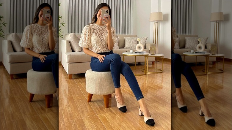 Smiling woman in jeans and white lace top