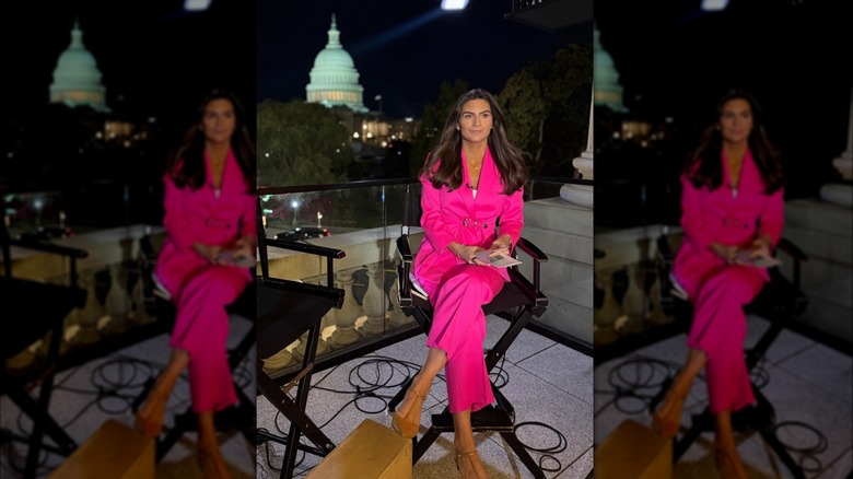 Kaitlan Collins wearing a hot pink pantsuit while sitting outside in D.C. in October 2025